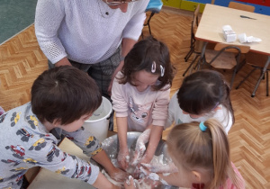 Dzieci tworzą z mąki ziemniaczanej i wody ciecz nienewtonowską , zabawa sensoryczna